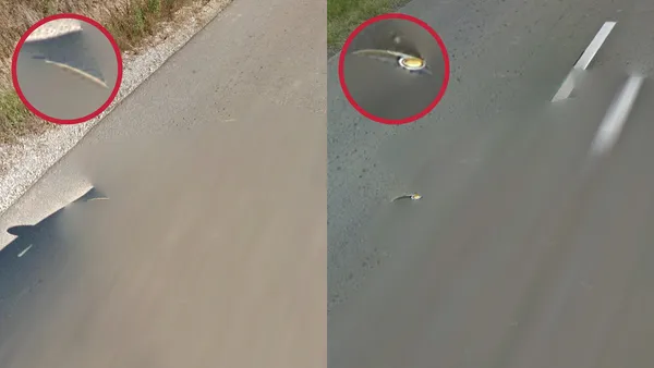 Размытый автомобиль с частично видимыми боковыми зеркалами на дороге