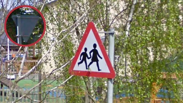 Асимметричный дорожный знак на столбе в британской Джерси